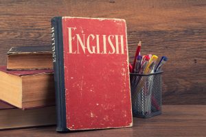 32020033 - learning english concept. book on a wooden background